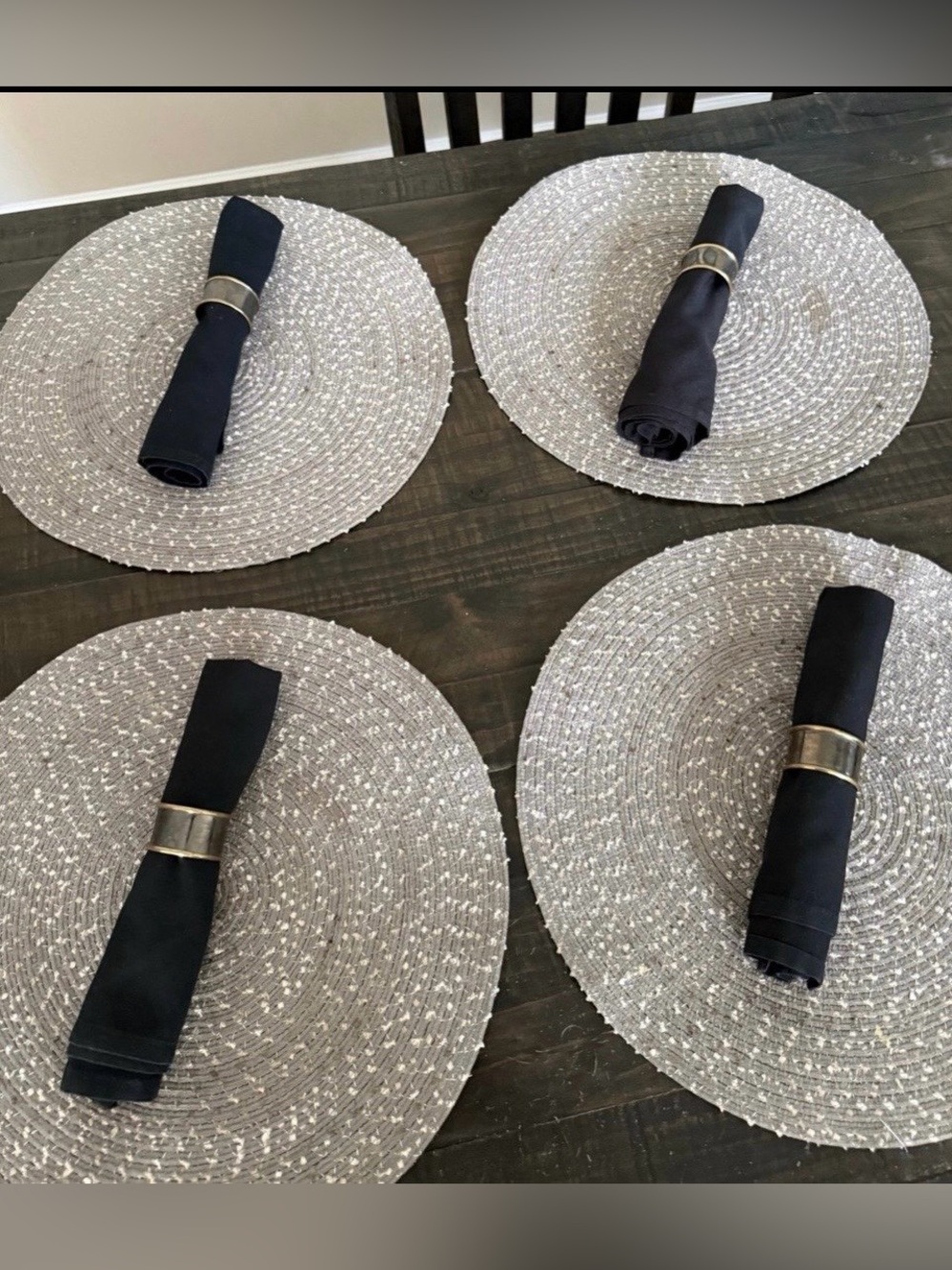 Set a four placemats with napkin rings and black napkins. 12 piece set